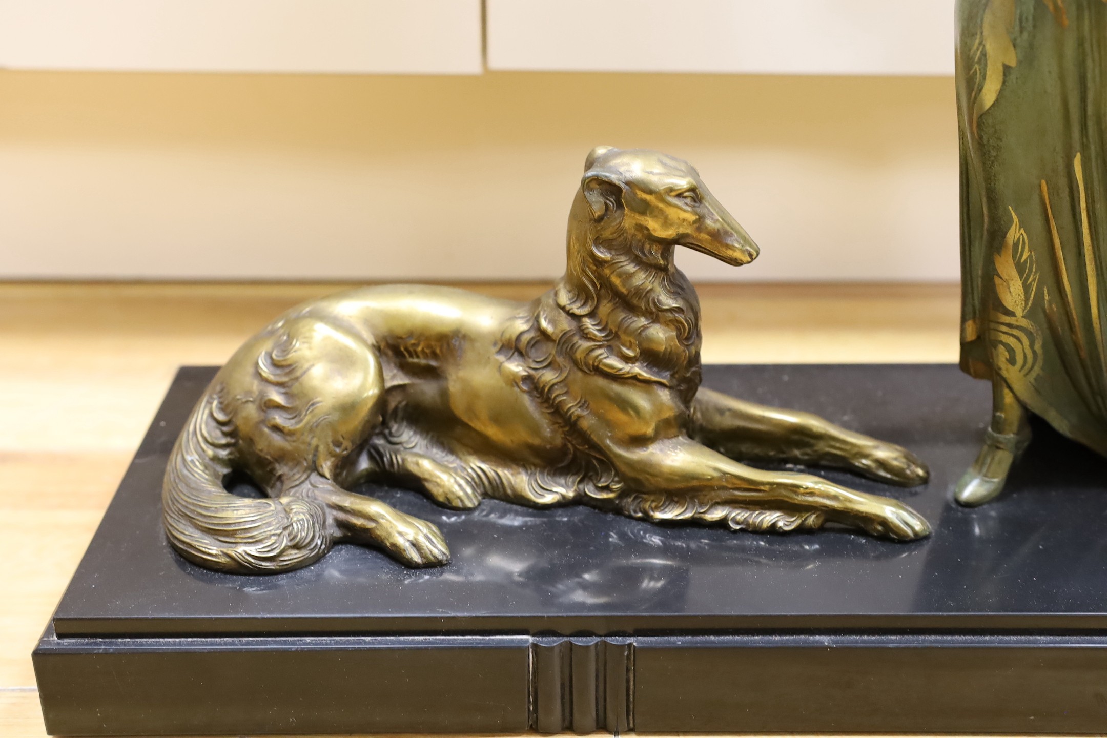 A French Art Deco female spelter figure and two bronzed spelter dogs on black marble base, signed Roggia. 74cm wide